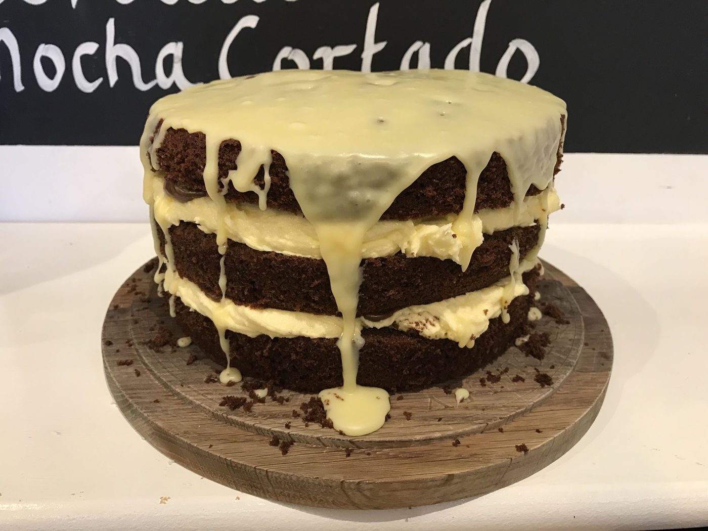 A layered chocolate cake with drizzled icing